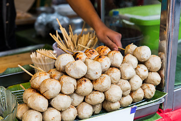 Image showing seller hand with meatballs at street market