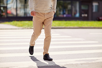 Image showing senior man walking along city crosswalk