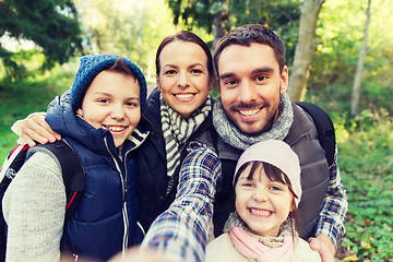 Image showing family with backpacks taking selfie and hiking