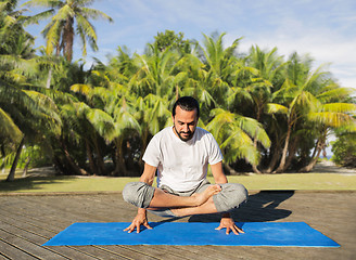 Image showing man making yoga in scale pose outdoors