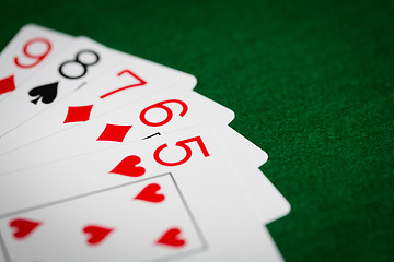 Image showing poker hand of playing cards on green casino cloth