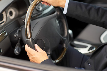 Image showing senior businessman hands driving car