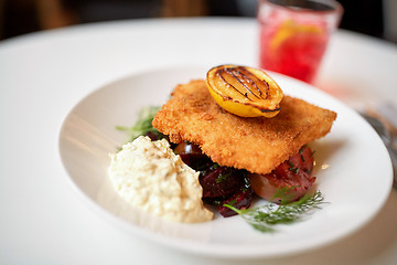 Image showing close up of fish salad with roasted lemon on plate