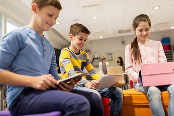 Image showing group of happy children with tablet pc at school