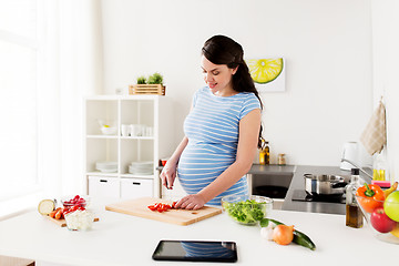 Image showing pregnant woman cooking vegetables at home