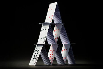 Image showing house of playing cards over black background