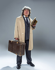 Image showing The senior man as detective or boss of mafia on gray studio background