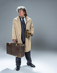 Image showing The senior man as detective or boss of mafia on gray studio background