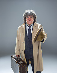 Image showing The senior man as detective or boss of mafia on gray studio background