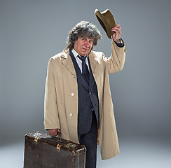 Image showing The senior man as detective or boss of mafia on gray studio background