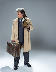 Image showing The senior man as detective or boss of mafia on gray studio background