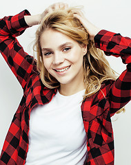 Image showing young pretty teenage hipster girl posing emotional happy smiling on white background, lifestyle people concept closeup