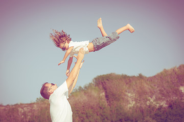 Image showing Father and son playing on the beach at the day time.