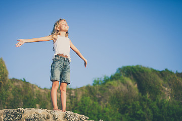 Image showing Happy little girl  standing on the beach