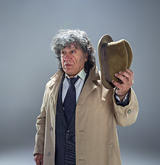 Image showing The senior man as detective or boss of mafia on gray studio background