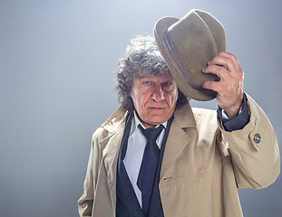 Image showing The senior man as detective or boss of mafia on gray studio background