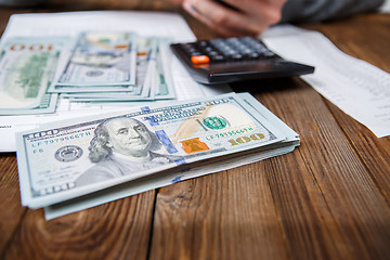 Image showing Blue leather wallet with money on wooden table