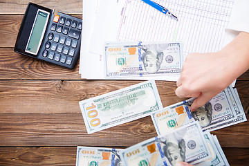 Image showing Hands hold and counting us dollar banknotes