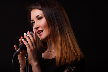 Image showing Singer with microphone in hands