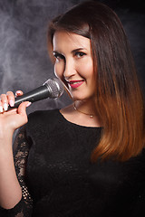 Image showing Singer in dress with microphone