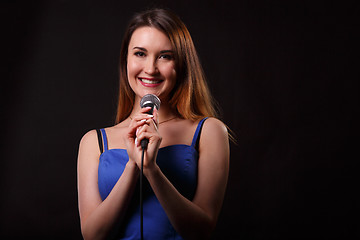 Image showing Singing woman on empty background