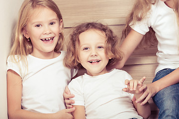 Image showing Portrait of happy children which are sitting on the stairs in th