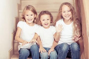 Image showing Portrait of happy children which are sitting on the stairs in th