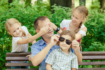 Image showing Father and children playing at the park at the day time.