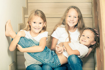 Image showing Portrait of happy children which are sitting on the stairs in th