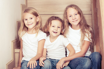 Image showing Portrait of happy children which are sitting on the stairs in th