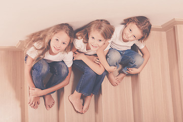 Image showing Portrait of happy children which are sitting on the stairs in th