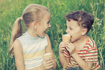 Image showing Three happy children  playing in park