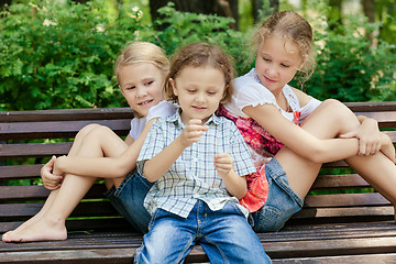 Image showing Three happy children  playing in park