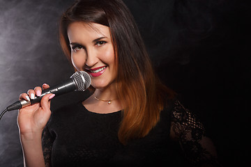 Image showing Girl in dress with microphone