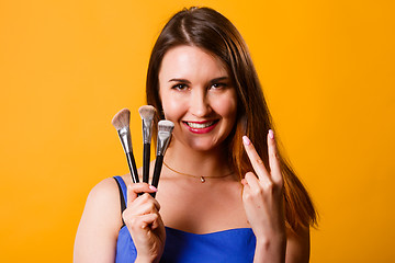 Image showing Beautiful brunette with makeup brushes