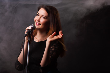 Image showing Singing woman on smoke background