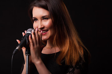 Image showing Woman with microphone in hands
