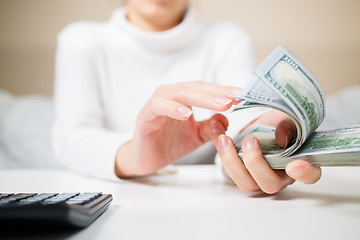 Image showing Woman countring money.