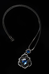 Image showing blue necklace on a black background. gems. 