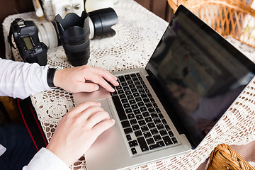 Image showing happy young man working on laptop outdoors