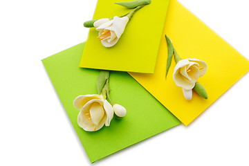 Image showing Close up of three yellow envelope with flowers