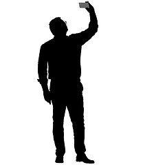 Image showing Silhouettes man taking selfie with smartphone on white background