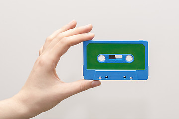 Image showing hand holding blue cassette tape