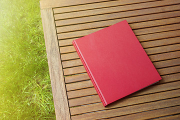 Image showing Red book on the outdoor table at coffee shop
