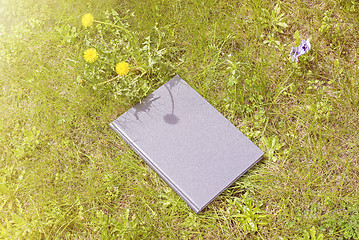 Image showing Grey book on the grass