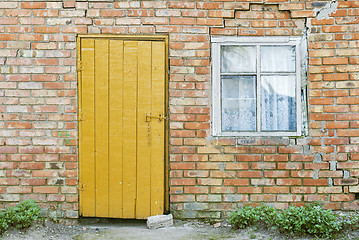 Image showing red brick wall, wooden door and window