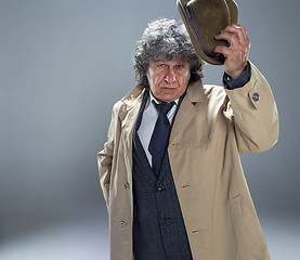 Image showing The senior man as detective or boss of mafia on gray studio background