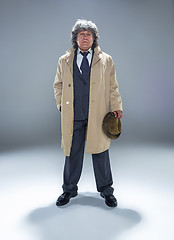 Image showing The senior man as detective or boss of mafia on gray studio background