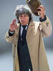 Image showing The senior man as detective or boss of mafia on gray studio background