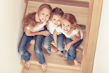 Image showing Portrait of happy children which are sitting on the stairs in th